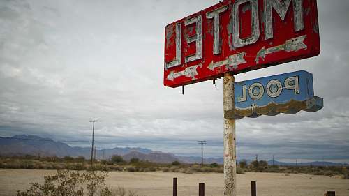 amargosa valley red motel signage in shallow focus clouds